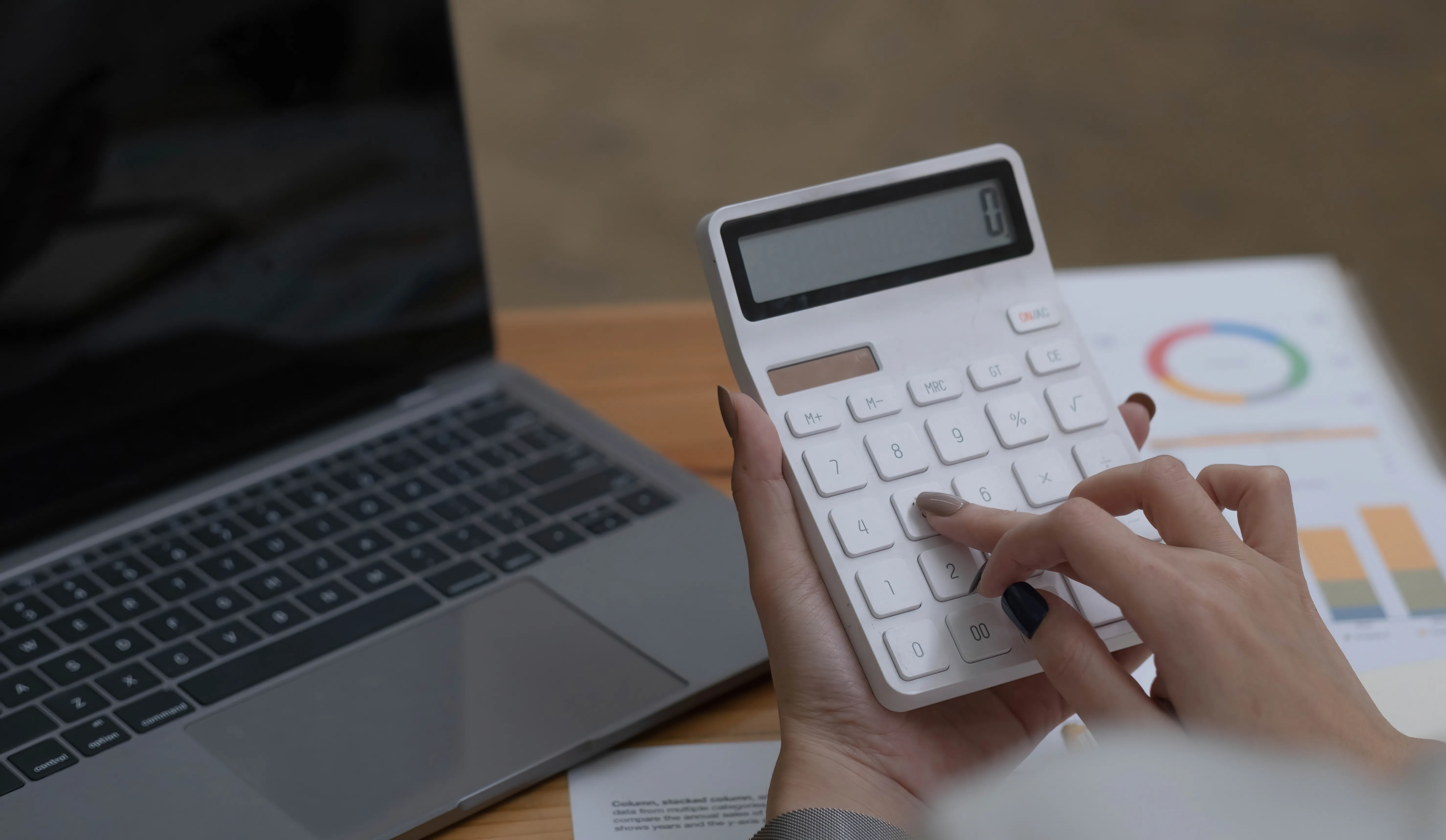 Woman using calculator and laptop