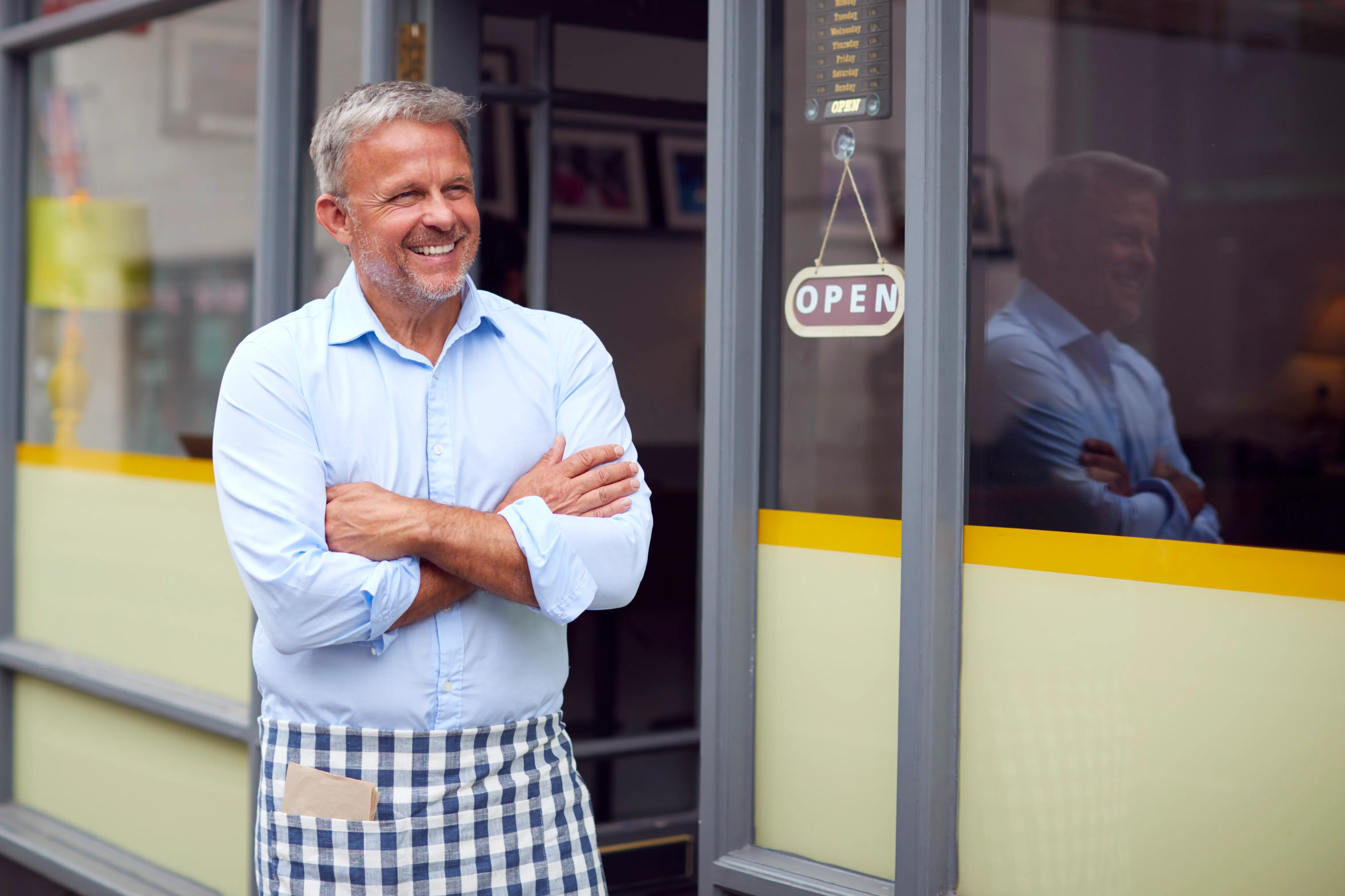 Business owner standing outside their shop